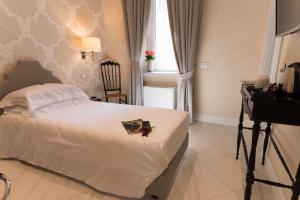 a bedroom with a bed and a desk and a window at Altavilla Boutique Hotel in Catanzaro