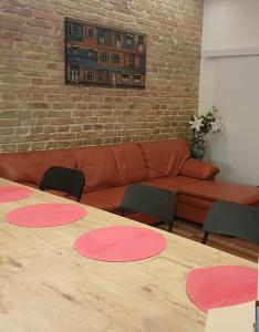 a table with pink circles on it in a room with a couch at Pacman Apartment in Budapest