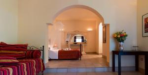 a bedroom with a bed and a table in a room at Oasi Di Casablanca in Lampedusa