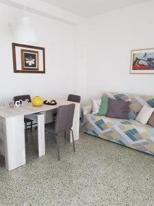 a living room with a table and a couch at Ca Enrico luxury flat in Monterosso al Mare