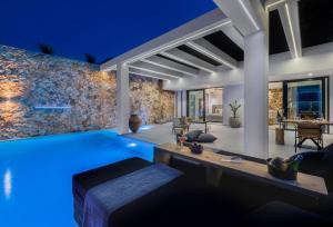 a villa with a swimming pool at night at Horizon Luxury Suite in Agios Nikolaos