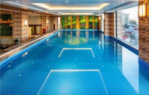 a swimming pool with blue water in a building at Thanh Lich Royal Boutique in Hue