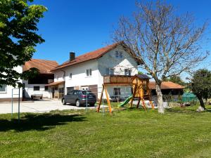 a playground in a yard in front of a house at Landhaus-Stockinger in Büchlberg