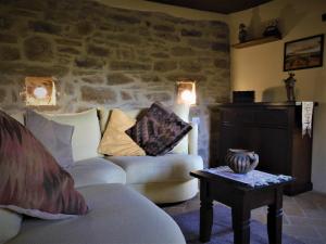 a living room with a couch and a table at Casale Grillo in Cortona