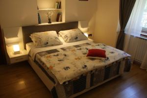 a bedroom with a bed with a blanket and pillows at Apartman Rino in Bašanija