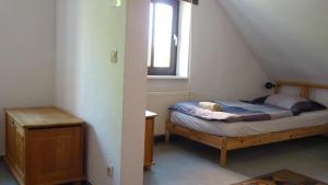 a small bedroom with a bed and a window at 404-Hostel in Cologne