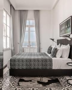 מיטה או מיטות בחדר ב-מלון רנומה