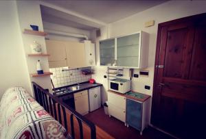a small kitchen with white cabinets and a sink at In Vacanza a Gaeta - Il Nido dell'Artista in Gaeta