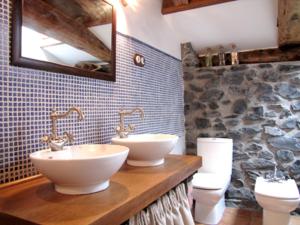 a bathroom with two sinks and two toilets at Apartamento rural Casa Arritxenea in Leitza