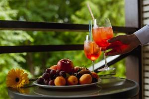 a table with two glasses and a plate of fruit at Vozdvizhenskoe Park Hotel in Serpukhov