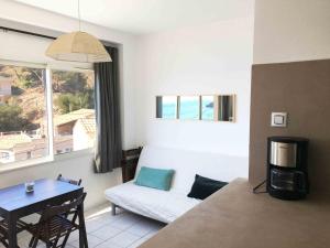 a living room with a couch and a table at Cabanon Sur L eau in Ensuès-la-Redonne +66 photos