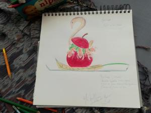 a drawing of a swan and an apple on a notebook at Locanda dei Mercanti in Crevacuore