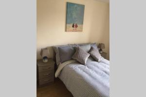 a bedroom with a bed and a painting on the wall at Waterfront apartment completely refurbished in Westport