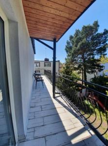 a balcony of a house with a wooden roof at Villa Marbela in Ustka