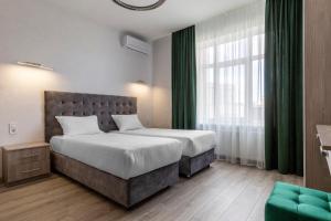 Ένα ή περισσότερα κρεβάτια σε δωμάτιο στο barasport city apartments +180 φωτογραφίες