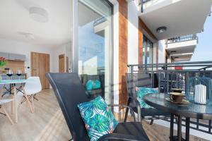 an empty balcony with a table and chairs at Morska 5 in Niechorze