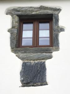 a window on the side of a building at La Casa Vieja de Caneo - APARTAMENTOS RURALES 3 llaves in Luarca