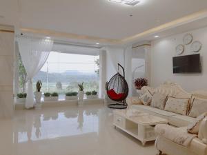 a living room with a couch and a large window at Minh Manh Hotel 2 in Pleiku