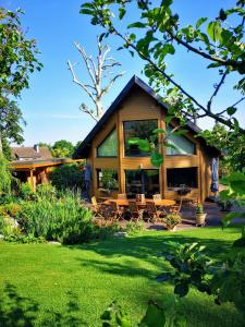 a house with a green yard at Les Chambres D'oriane in Chessy