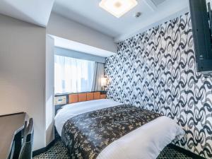 Letto o letti in una camera di APA Hotel & Resort Ryogoku Eki Tower