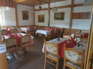 a dining room with tables and chairs with red tablecloths at Lei's WOK in Neusiedl am See