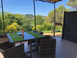 a patio with a table with tennis courts on it at Résidence Château Saint Martin in Saint-Martin-dʼArdèche