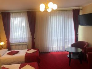Posteľ alebo postele v izbe v ubytovaní Hotel Sekwana