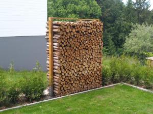 a stack of fire wood in a garden at Ferienwohnung Tischneck in Schramberg
