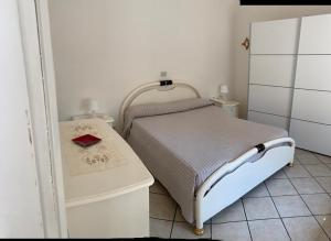 a small bedroom with a bed and a table at La casina dell'Annetta in Lido di Camaiore