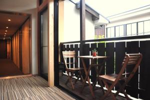 
a wooden dining room with a wooden table and chairs at Guesthouse Soi in Kyoto
