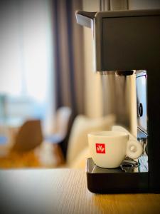 a coffee maker and a cup on a table at Crops City Stay in Trieste