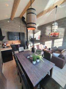 a dining room and living room with a table and chairs at Seaview cabin Reine, Lofoten in Reine