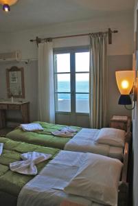 A bed or beds in a room at Vrohaki Studios & Rooms