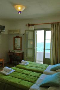 A bed or beds in a room at Vrohaki Studios & Rooms