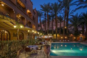 a hotel with a swimming pool at night at Kasbah Sirocco in Zagora