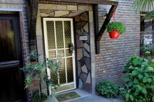 a front door of a brick house with a plant at Villakunterbunt in Nettetal +5 photos