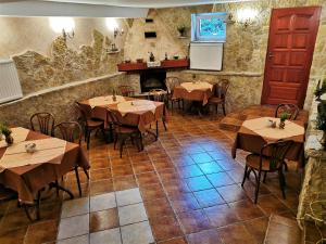 a restaurant with tables and chairs and a fireplace at Dom pod Tujami in Krakow +27 photos