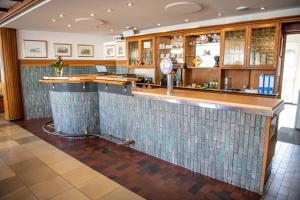 a bar in a restaurant with a counter at Hotel Zur Aue in Wesel
