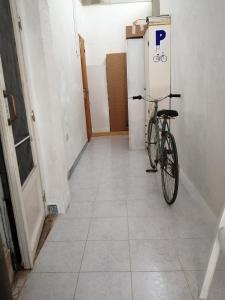 a bike parked in a hallway next to a refrigerator at Can Ventura in Deltebre