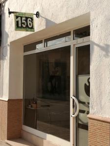 a sliding glass door with a sign on the side of a building at Can Ventura in Deltebre