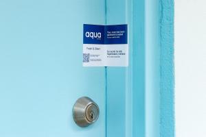 a blue door with a sign on it at Aqua Hotel & Suites in Miami Beach