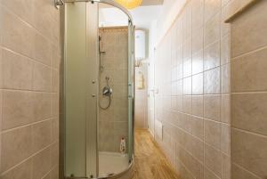 a shower with a glass door in a bathroom at Alghero P.Umberto old town in Alghero