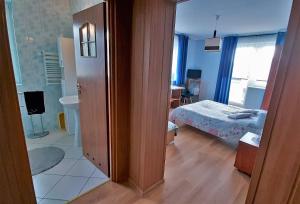 a room with a bedroom with a bed and a bathroom at Willa Pasat in Władysławowo +49 photos