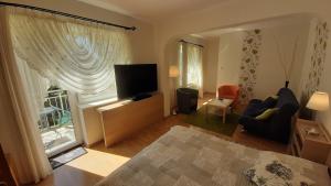 a living room with a large window and a television at Willa Pasat in Władysławowo