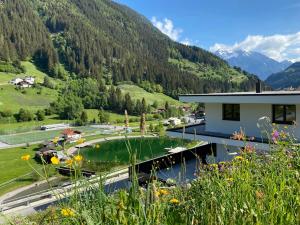 a house with a pond in a valley with mountains at see.view apartment in See