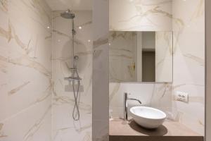 a bathroom with a sink and a shower at The Market by Parkhotel in Kortrijk