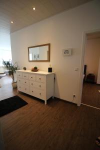 a room with a white dresser and a mirror at City Schloss Viktoria in Koblenz