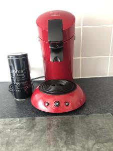 a red blender sitting on top of a counter at Hyper-Centre historique avec possibilité de réservation parking in Toulouse