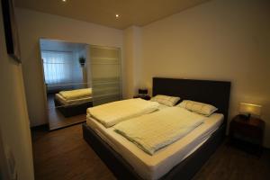 a bedroom with a large bed and a mirror at City Schloss Viktoria in Koblenz +17 photos