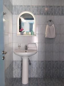 a bathroom with a sink and a mirror at Mastorakis Village in Agia Marina Nea Kydonias